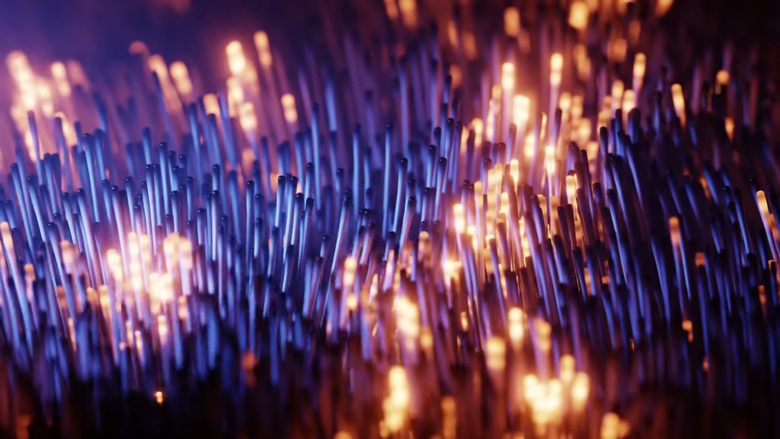 Macro de hebras de fibra &oacute;ptica en azul y oro, en profundidad de campo corta
